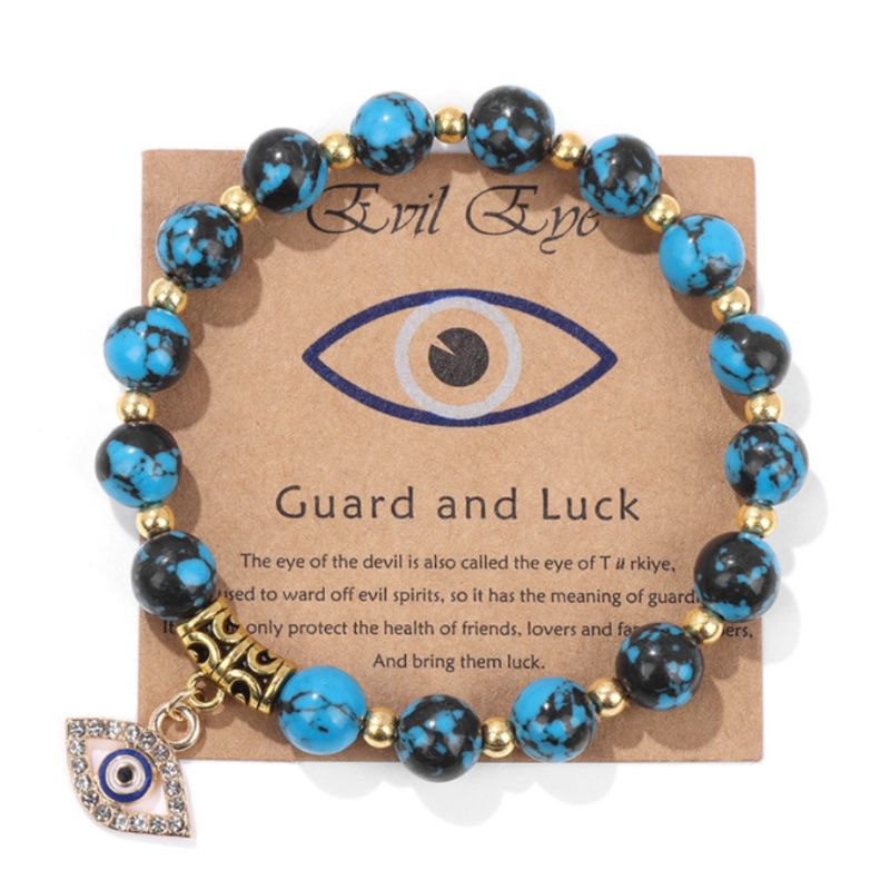 Blaues Edelstein Perlen Armband mit goldenen Details und Glitzer Auge Anhänger 