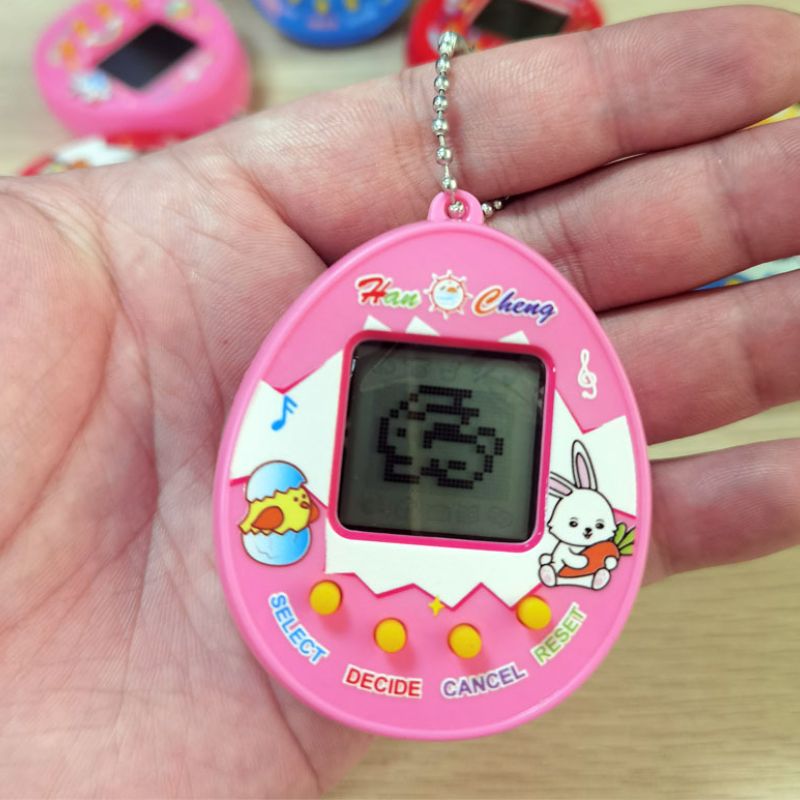 90er Trend Spielzeug Tamagotchi ist zurück - Rosa virtuelles Haustier bestellen 