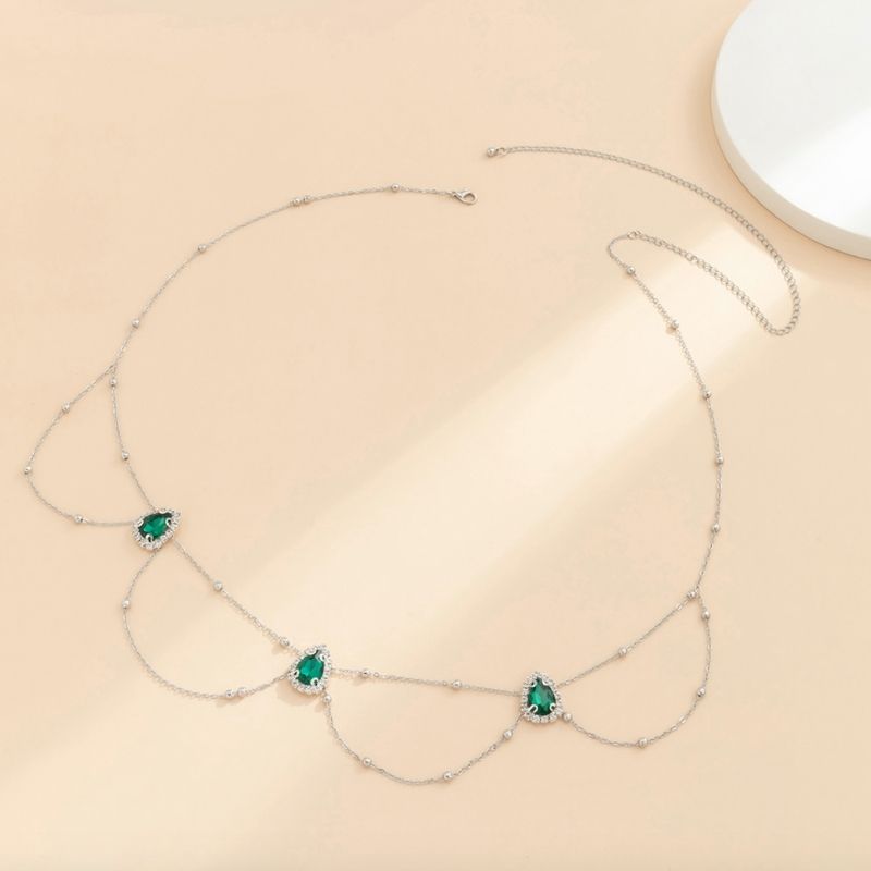 Damen Modeschmuck Bauchkette in silber mit gruenen Steinen 