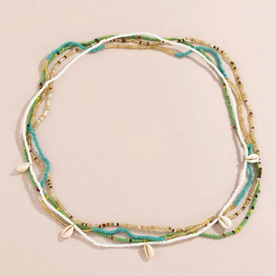 Bauchketten Set aus farbigen Perlenketten in gruen, gold, tuerkis und weiss mit Muscheln